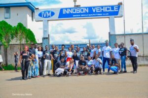 A group photo of the students in front of the Innoson vehicle co ltd building